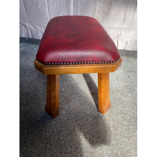 104 - A RED LEATHER UPHOLSTERED FOOTSTOOL, deep red leather stud upholstered, on carved hardwood base. Dim... 