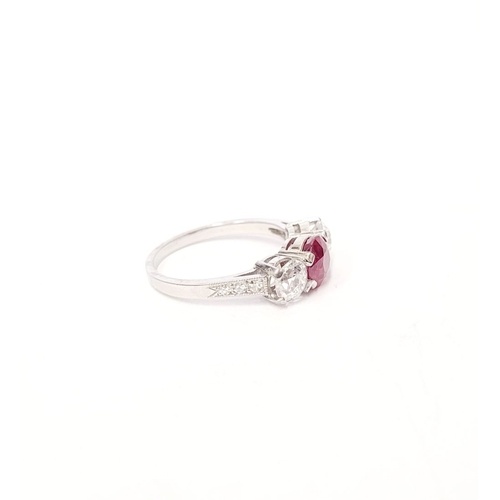 11 - A PRETTY THREE STONE DIAMOND & RUBY RING, the central ruby stone 1.65cts, flanked by a round cut dia... 