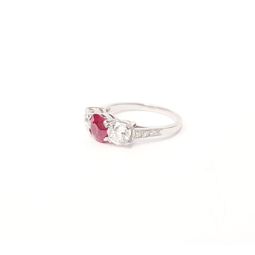 11 - A PRETTY THREE STONE DIAMOND & RUBY RING, the central ruby stone 1.65cts, flanked by a round cut dia... 