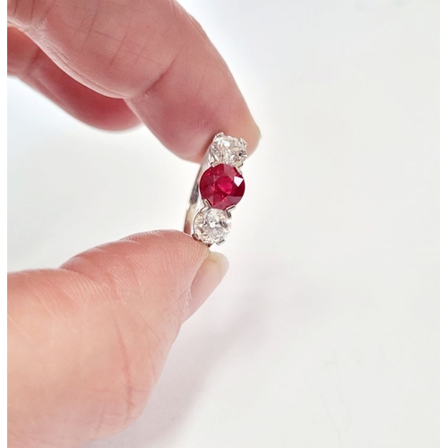 11 - A PRETTY THREE STONE DIAMOND & RUBY RING, the central ruby stone 1.65cts, flanked by a round cut dia... 