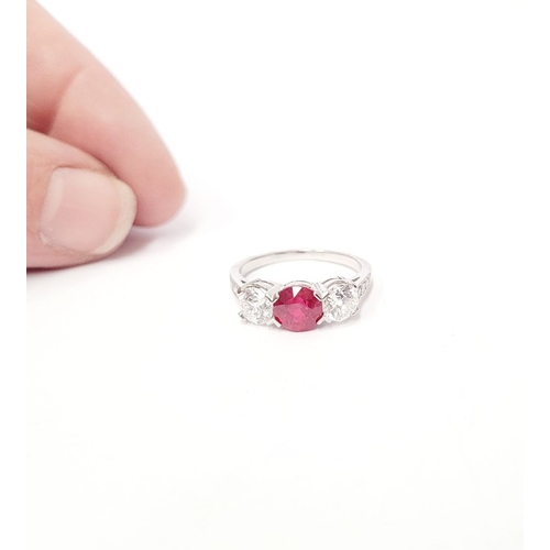 11 - A PRETTY THREE STONE DIAMOND & RUBY RING, the central ruby stone 1.65cts, flanked by a round cut dia... 