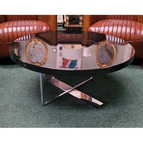 114 - A CONTEMPORARY PORADA LOW RISE CIRCULAR COFFEE TABLE, with chrome metal base, and black circular top... 