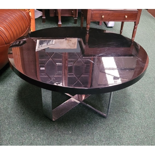 114 - A CONTEMPORARY PORADA LOW RISE CIRCULAR COFFEE TABLE, with chrome metal base, and black circular top... 