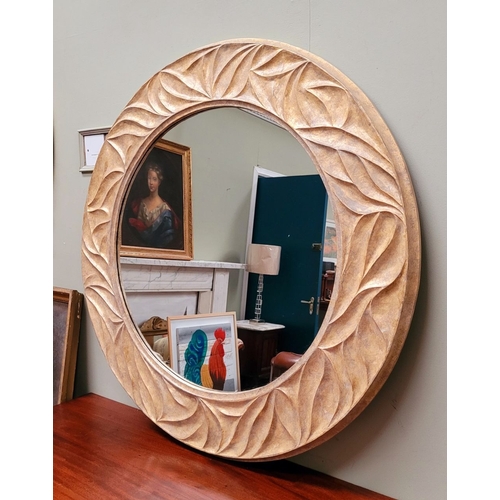 118 - A VERY GOOD QUALITY PORTA ROMANA GILT COLOURED CIRCULAR WALL MIRROR, with wave type design to the fr... 