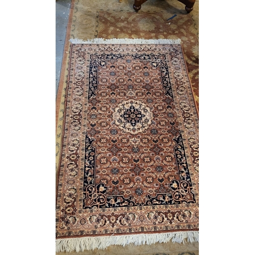 129 - A GOOD QUALITY TAPRIZ FLOOR RUG, with floral design, having a central medallion, and long fringe to ... 