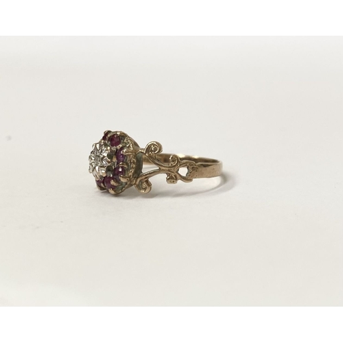 133 - A UNIQUE VINTAGE 9CT YELLOW GOLD DIAMOND AND RUBY CLUSTER RING, with central round cut diamond in il... 