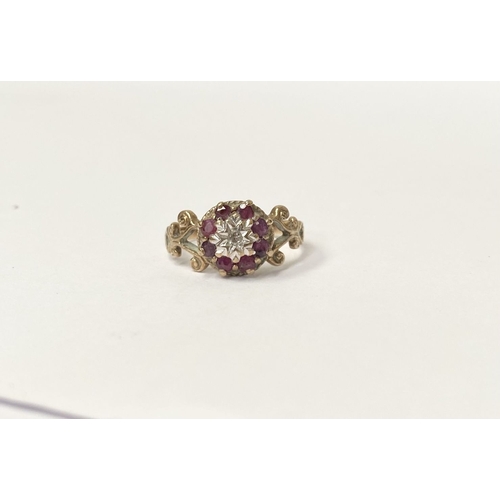 133 - A UNIQUE VINTAGE 9CT YELLOW GOLD DIAMOND AND RUBY CLUSTER RING, with central round cut diamond in il... 