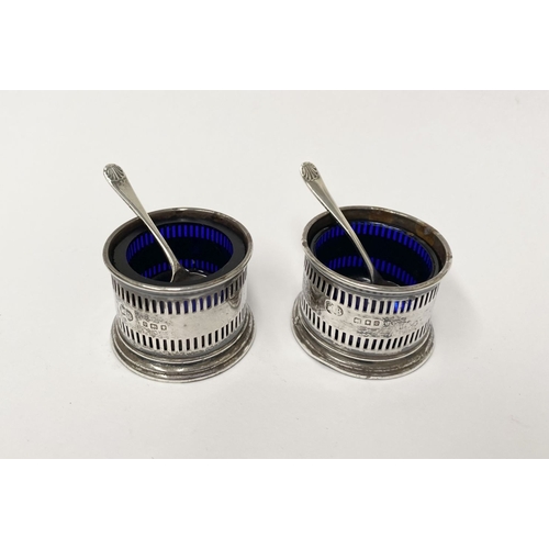 134 - A PAIR OF SILVER SALTS WITH SPOONS, the salts with blue glass liners and openwork design to body, on... 