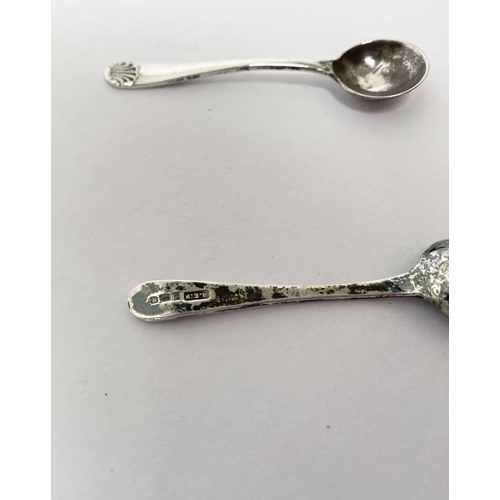 134 - A PAIR OF SILVER SALTS WITH SPOONS, the salts with blue glass liners and openwork design to body, on... 