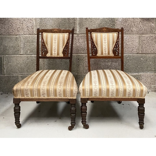 136 - A PAIR OF VICTORIAN ROSEWOOD INLAID NURSING CHAIRS, with upholstery to backrest surrounded by scroll... 