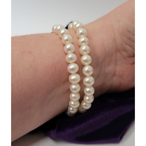 16 - A BEAUTIFUL DOUBLE ROW PEARL BRACELET WITH GEORGIAN GOLD CLAPS which holds a stone within it. The cl... 