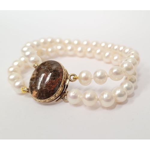 16 - A BEAUTIFUL DOUBLE ROW PEARL BRACELET WITH GEORGIAN GOLD CLAPS which holds a stone within it. The cl... 