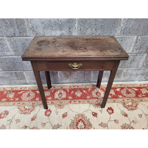 164 - A FOLD OVER TEA TABLE, with gate leg to back, a single frieze drawer with brass swan neck handle and... 