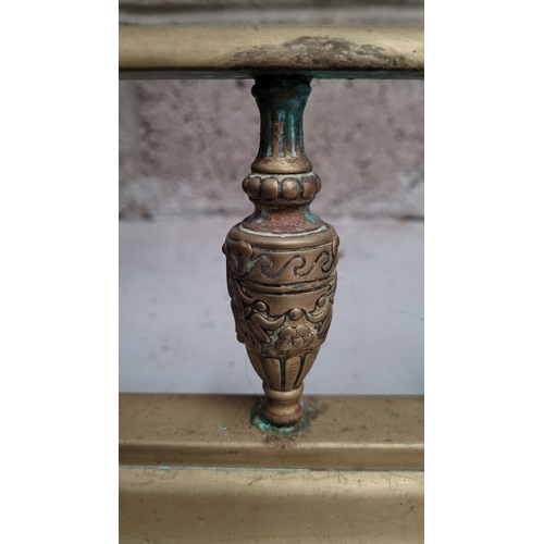 165 - A GOOD QUALITY BRASS FIRE FENDER, with raised gallery sides decorated with ribbon detail to the upri... 