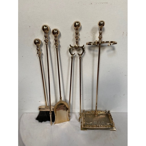 187 - A VERY GOOD QUALITY SET OF POLISHED BRASS FIRE IRONS, with stand, includes a shovel, brush, poker & ... 