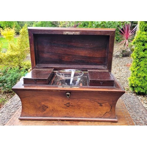 205 - A 19TH CENTURY ROSEWOOD SARCOPHAGUS SHAPED TEA CADDY, with hinged lid which opens to reveal two tea ... 