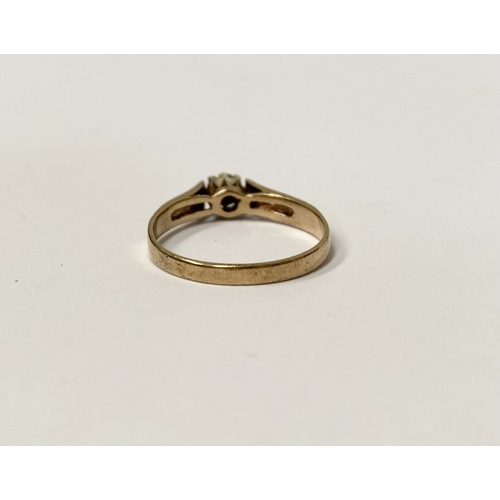 207 - A VINTAGE 9CT YELLOW GOLD DIAMOND SOLITAIRE RING, with central round cut diamond in raised decorativ... 