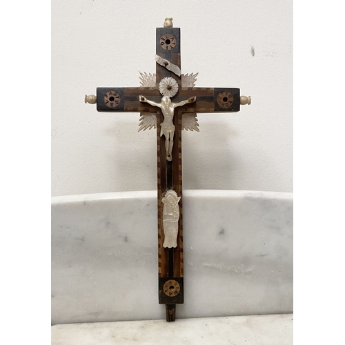 216 - A VINTAGE CARVED FRUITWOOD RELIGIOUS RELIEF ALONG WITH A HARDWOOD MOTHER OF PEARL CRUCIFIX, with car... 