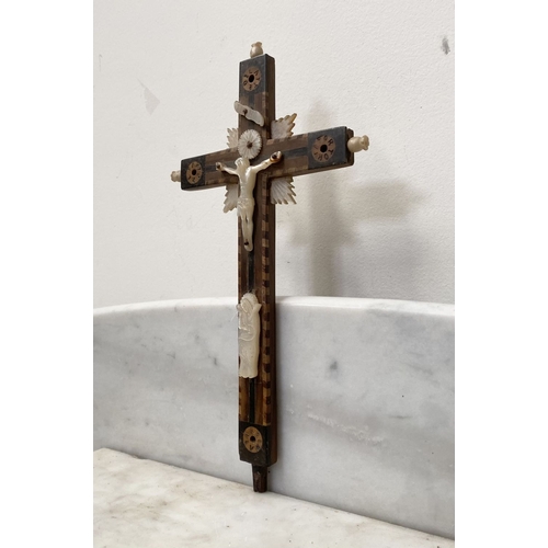 216 - A VINTAGE CARVED FRUITWOOD RELIGIOUS RELIEF ALONG WITH A HARDWOOD MOTHER OF PEARL CRUCIFIX, with car... 