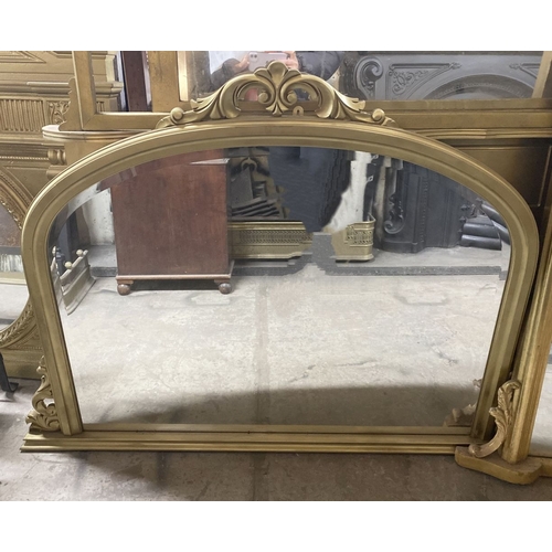 223 - A FINE BEVELLED GLASS GILT OVERMANTLE MIRROR, the arched bevelled glass within gilt frame with scrol... 