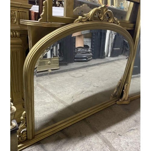 223 - A FINE BEVELLED GLASS GILT OVERMANTLE MIRROR, the arched bevelled glass within gilt frame with scrol... 