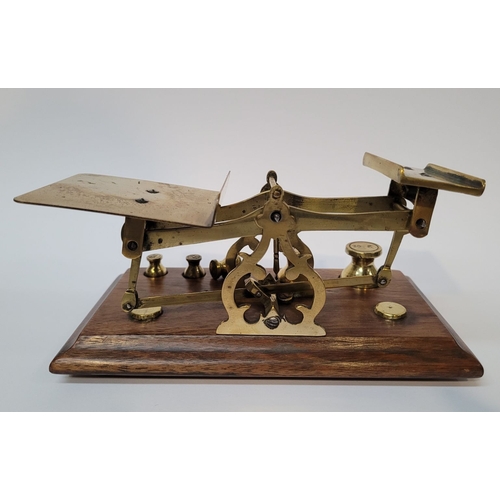 227 - A VINTAGE OAK & BRASS TABLE TOP SCALES, impressed ‘Warranted Accurate’ to the uprights. Comes with 5... 