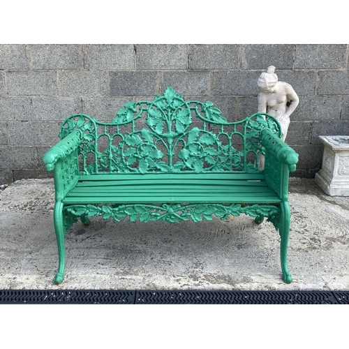 232 - A VERY GOOD QUALITY PAINTED CAST IRON GARDEN BENCH, decorated with scrolling oak leaf decoration to ... 