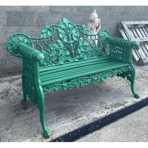 232 - A VERY GOOD QUALITY PAINTED CAST IRON GARDEN BENCH, decorated with scrolling oak leaf decoration to ... 