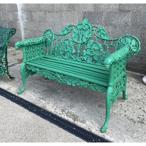 232 - A VERY GOOD QUALITY PAINTED CAST IRON GARDEN BENCH, decorated with scrolling oak leaf decoration to ... 