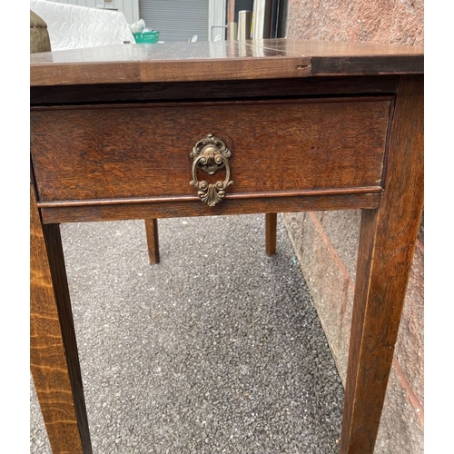 237 - AN ANTIQUE OAK SIDE TABLE, a single drawer to one side with ornate brass handles; faux drawer to opp... 