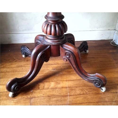 239 - A GOOD QUALITY ANTIQUE BURR WALNUT OVAL SHAPED TIP UP TABLE, raised on a turned column support with ... 