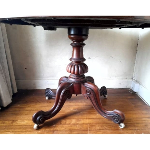 239 - A GOOD QUALITY ANTIQUE BURR WALNUT OVAL SHAPED TIP UP TABLE, raised on a turned column support with ... 