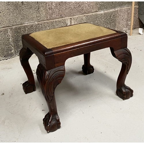 271 - A FINE MAHOGANY UPHOLSTERED FOOTSTOOL, with carving to knee, standing on claw and ball foot. Dimensi... 