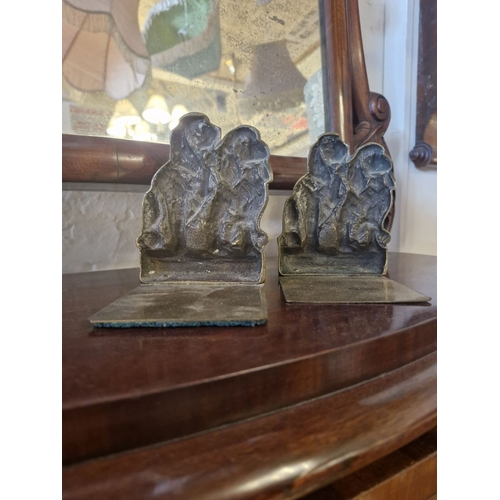 284 - A CHARMING PAIR OF BRASS BOOKENDS – IN THE FORM OF A PAIR OF SPANIELS SEATED, and with the words Spa... 