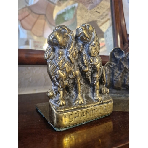 284 - A CHARMING PAIR OF BRASS BOOKENDS – IN THE FORM OF A PAIR OF SPANIELS SEATED, and with the words Spa... 