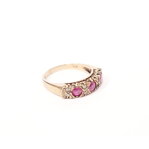 34 - A VINTAGE 9CT YELLOW GOLD 11 STONE DIAMOND & RUBY RING, with raised setting, three round cut rubies ... 