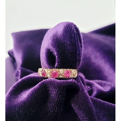 34 - A VINTAGE 9CT YELLOW GOLD 11 STONE DIAMOND & RUBY RING, with raised setting, three round cut rubies ... 