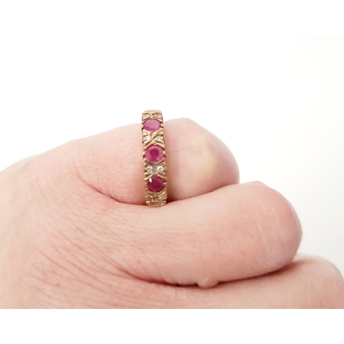 34 - A VINTAGE 9CT YELLOW GOLD 11 STONE DIAMOND & RUBY RING, with raised setting, three round cut rubies ... 