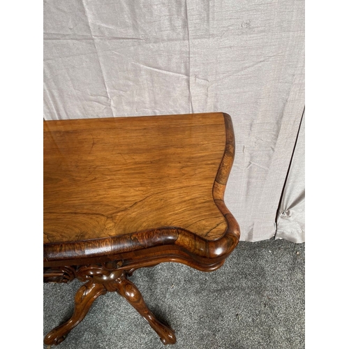 4 - A VICTORIAN ROSEWOOD CARD TABLE, with shaped top opening to green baize lined interior, above frieze... 