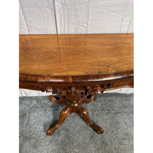 4 - A VICTORIAN ROSEWOOD CARD TABLE, with shaped top opening to green baize lined interior, above frieze... 