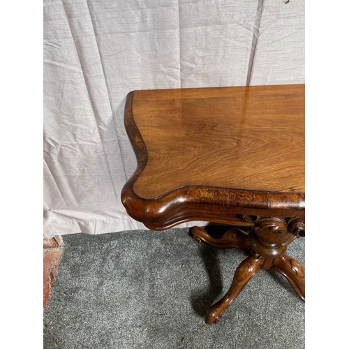 4 - A VICTORIAN ROSEWOOD CARD TABLE, with shaped top opening to green baize lined interior, above frieze... 