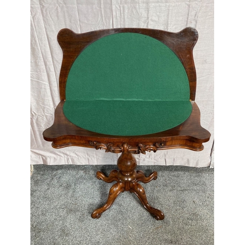 4 - A VICTORIAN ROSEWOOD CARD TABLE, with shaped top opening to green baize lined interior, above frieze... 