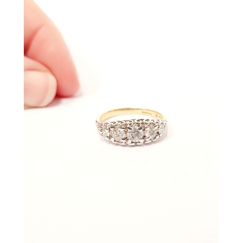 47 - AN 18CT YELLOW GOLD FIVE STONE DIAMOND RING, the graduated stones in a raised wave setting. Estimate... 