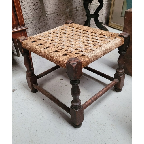 50 - A SMALL IRISH SÚGÁN STOOL, with turned wooden legs united by rounded bar stretchers and a woven seat... 