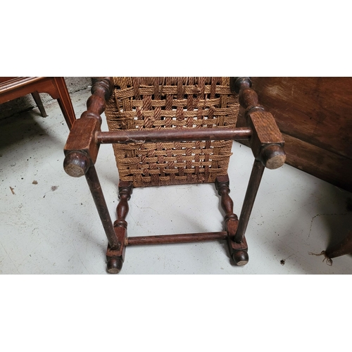 50 - A SMALL IRISH SÚGÁN STOOL, with turned wooden legs united by rounded bar stretchers and a woven seat... 