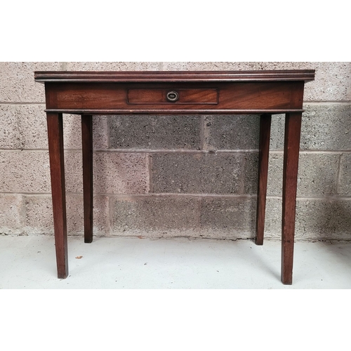 56 - A GEORGIAN MAHOGANY FOLD OVER TEA TABLE, with a single narrow drawer to the front frieze with brass ... 