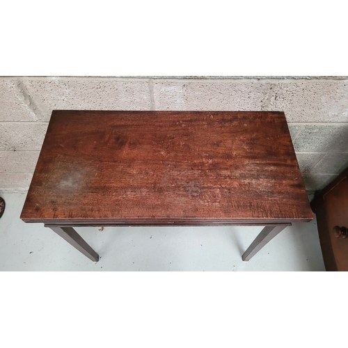 56 - A GEORGIAN MAHOGANY FOLD OVER TEA TABLE, with a single narrow drawer to the front frieze with brass ... 