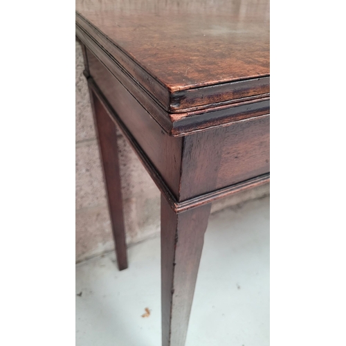 56 - A GEORGIAN MAHOGANY FOLD OVER TEA TABLE, with a single narrow drawer to the front frieze with brass ... 