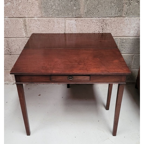 56 - A GEORGIAN MAHOGANY FOLD OVER TEA TABLE, with a single narrow drawer to the front frieze with brass ... 