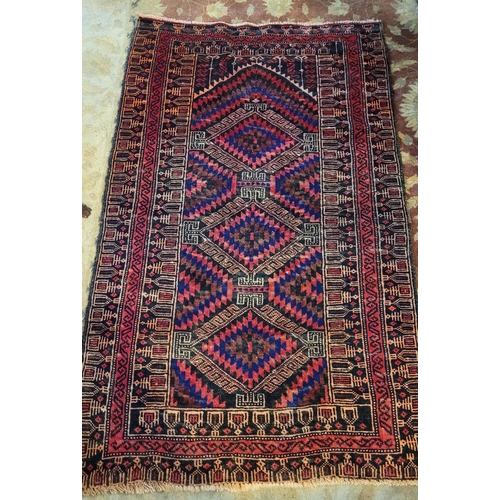 70 - A VERY GOOD QUALITY WOOVEN NEAT SIZED BALUCH FLOOR RUG, with triple diamond shaped medallions to the... 